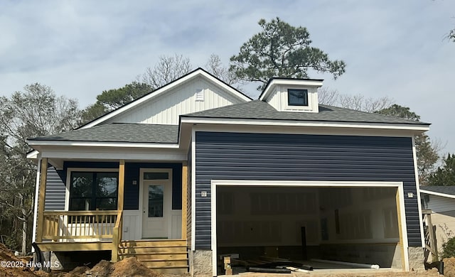 view of front of home with a porch, an attached garage, and a shingled roof