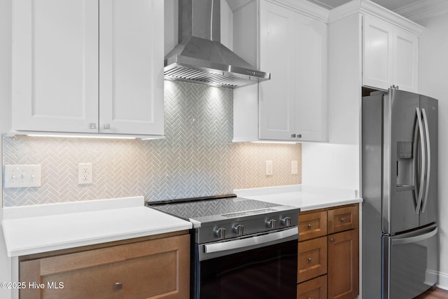 kitchen with stainless steel fridge with ice dispenser, tasteful backsplash, range with electric stovetop, and wall chimney exhaust hood