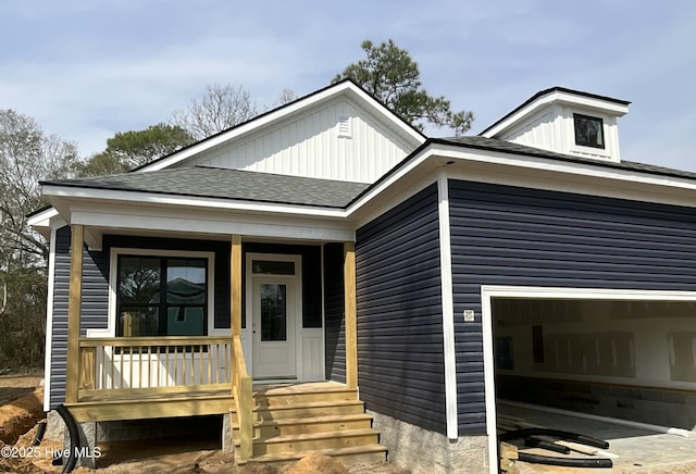 view of front of property with a garage, a porch, and roof with shingles