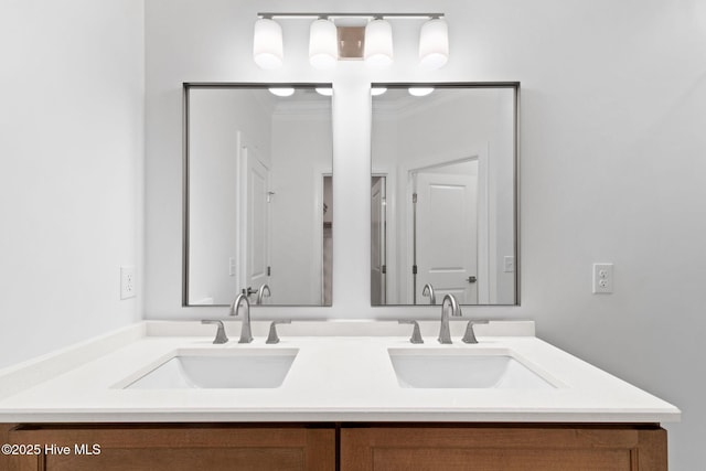 full bath with double vanity, ornamental molding, and a sink