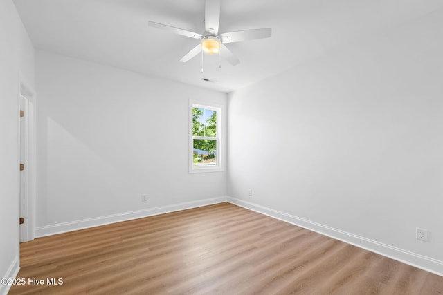unfurnished room featuring baseboards, a ceiling fan, and wood finished floors