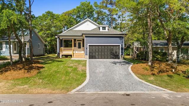 view of front of house featuring a garage, a front lawn, gravel driveway, roof with shingles, and a porch