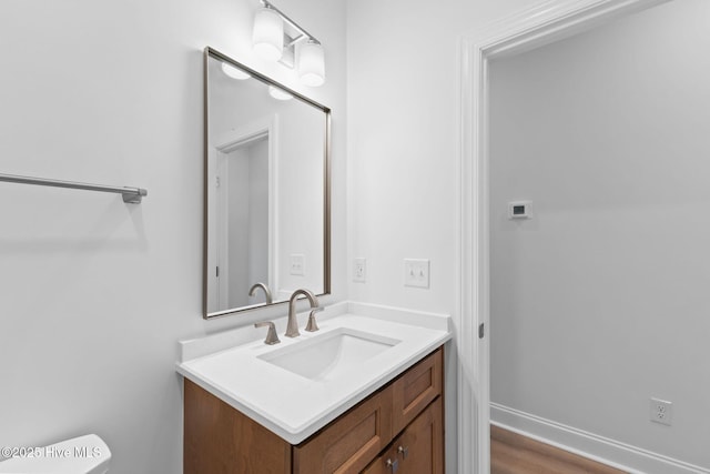 half bathroom with toilet and vanity