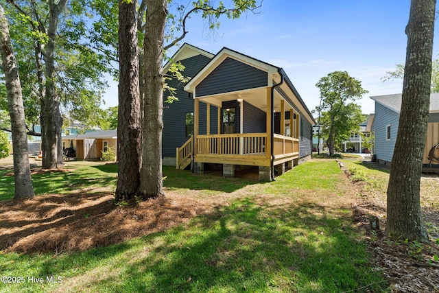 rear view of property with a yard