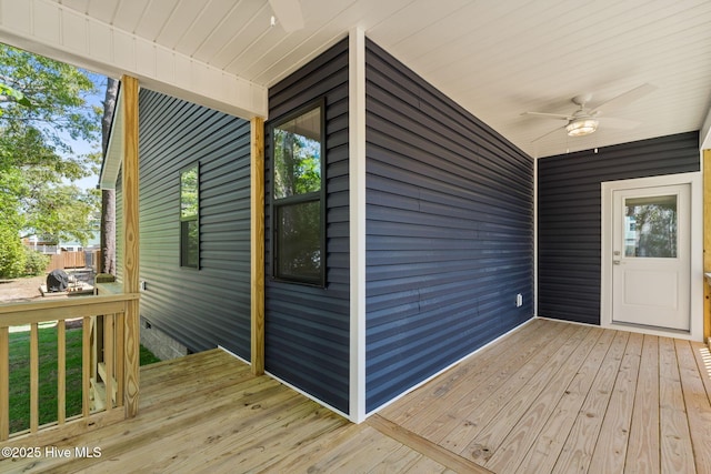 wooden deck with a ceiling fan