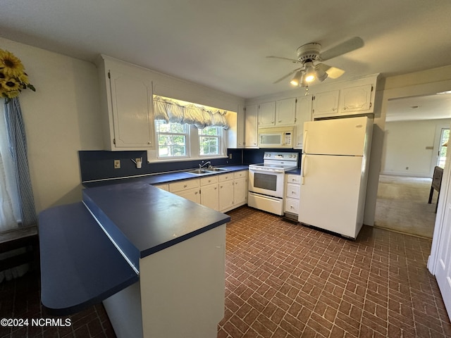 kitchen featuring a sink, white appliances, dark countertops, and white cabinetry