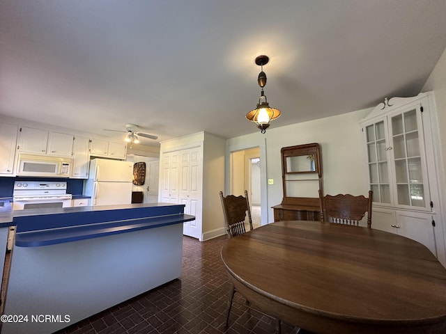 dining room with brick floor and ceiling fan