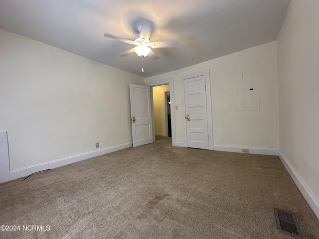 unfurnished bedroom with electric panel, visible vents, carpet floors, and baseboards