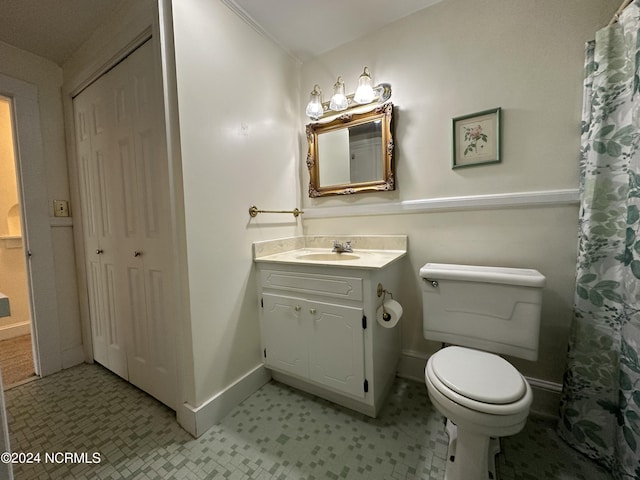 full bathroom with vanity, toilet, and baseboards