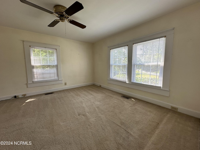 unfurnished room featuring carpet flooring, baseboards, and visible vents