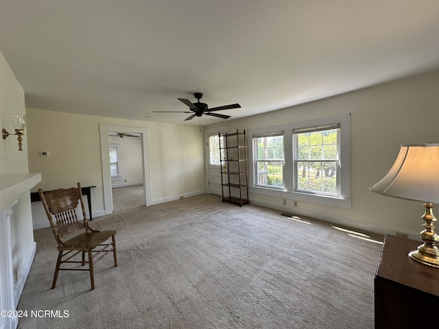 sitting room featuring baseboards, carpet, and ceiling fan