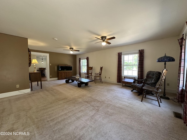 sitting room with visible vents, plenty of natural light, and carpet