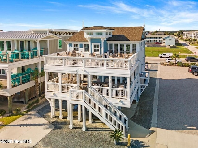 exterior space with stairway, a residential view, and driveway