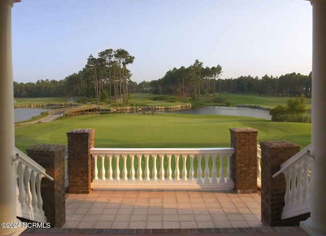 view of patio featuring a water view and golf course view