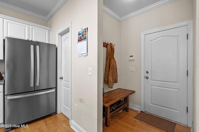 mudroom featuring light wood-style flooring, baseboards, and ornamental molding