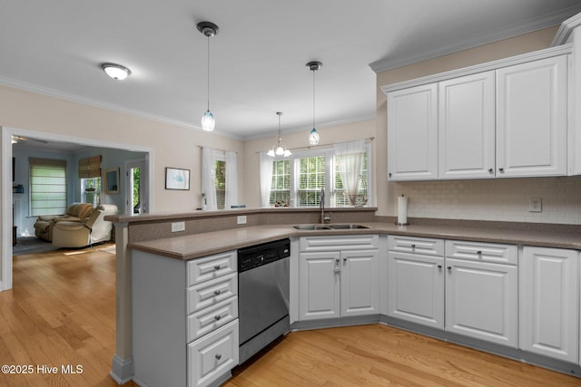 kitchen featuring stainless steel dishwasher, crown molding, light wood-style flooring, and a sink