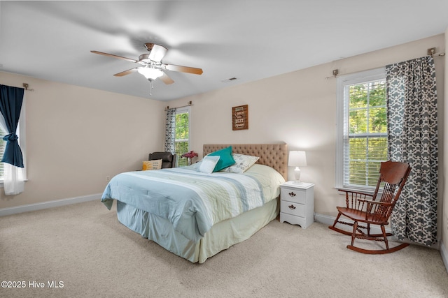 carpeted bedroom featuring visible vents, ceiling fan, and baseboards