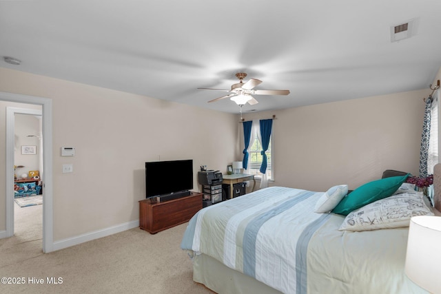 bedroom with visible vents, baseboards, light colored carpet, and a ceiling fan