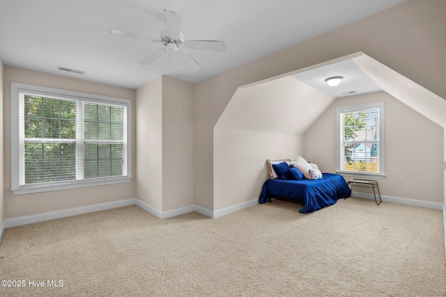 carpeted bedroom featuring visible vents, a ceiling fan, lofted ceiling, and baseboards