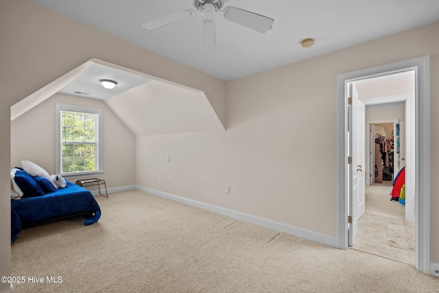 carpeted bedroom with baseboards, lofted ceiling, and a ceiling fan