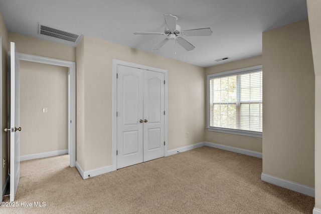 unfurnished bedroom with visible vents, carpet flooring, and baseboards