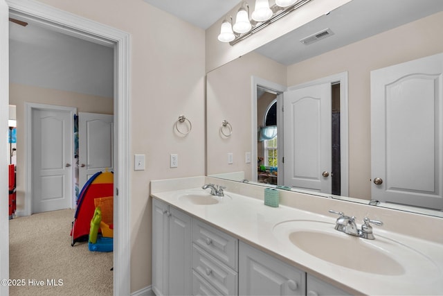 bathroom with a sink, visible vents, and double vanity