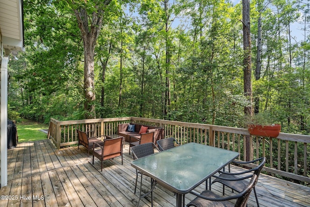 wooden terrace featuring outdoor dining space and an outdoor hangout area