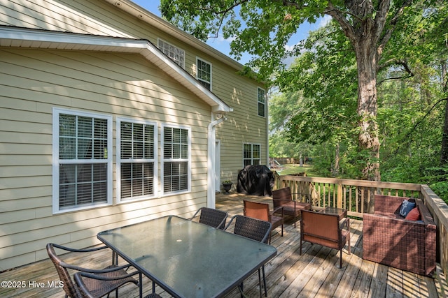 deck featuring outdoor dining space and area for grilling