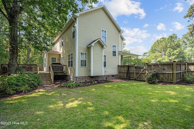 back of house featuring a gate, fence, a yard, a wooden deck, and crawl space