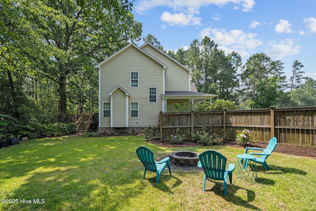 rear view of house featuring stairway, fence, a yard, a fire pit, and crawl space