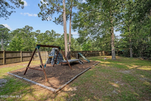 view of play area with a lawn and a fenced backyard