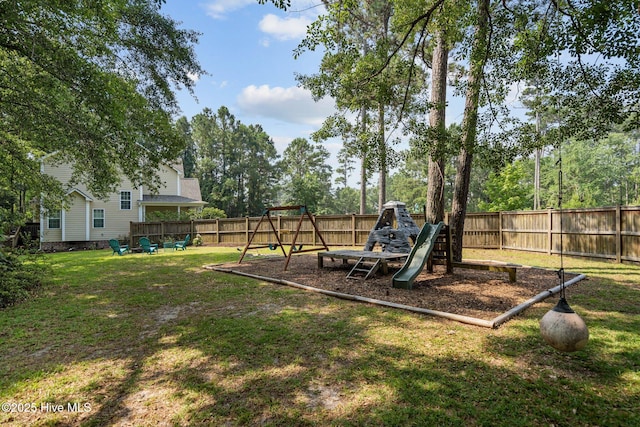 view of yard featuring a playground and a fenced backyard