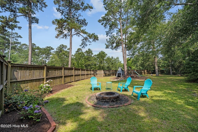 view of yard featuring a fenced backyard and an outdoor fire pit