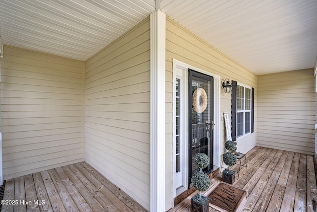 view of exterior entry with covered porch