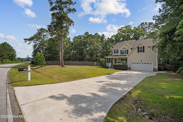 view of front of property with an attached garage, a front lawn, fence, covered porch, and driveway