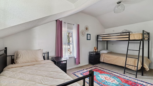 carpeted bedroom featuring a textured ceiling, baseboards, and vaulted ceiling