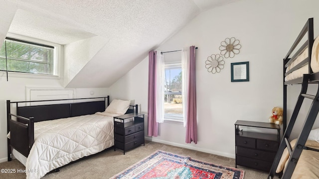 bedroom featuring multiple windows, a textured ceiling, lofted ceiling, and carpet floors