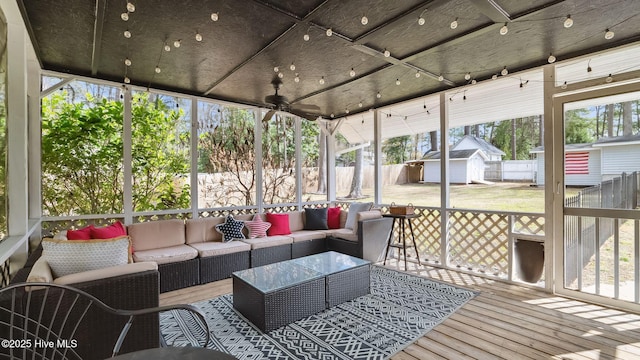 sunroom featuring ceiling fan