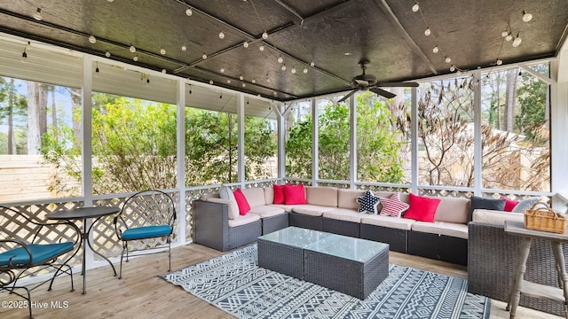 sunroom / solarium featuring a ceiling fan