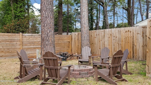 view of yard featuring an outdoor fire pit and a fenced backyard