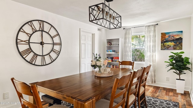 dining area featuring visible vents, baseboards, and dark wood-style floors