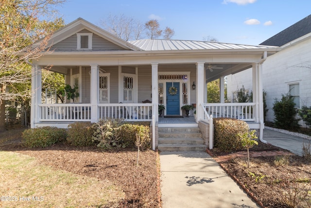 view of front of house featuring a standing seam roof, covered porch, and metal roof