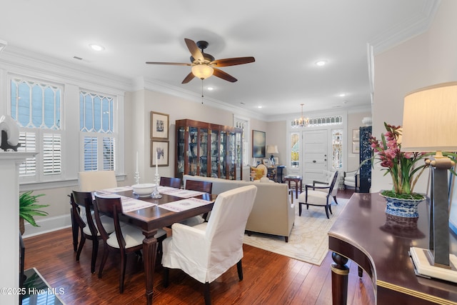 dining area with a wealth of natural light, ceiling fan with notable chandelier, crown molding, and wood-type flooring