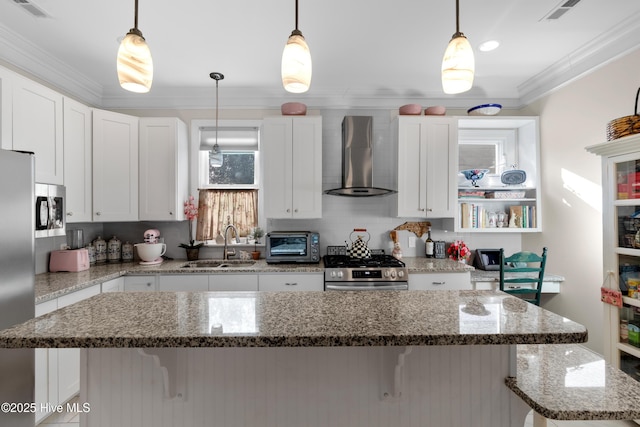 kitchen featuring a sink, a kitchen breakfast bar, stainless steel appliances, wall chimney exhaust hood, and crown molding