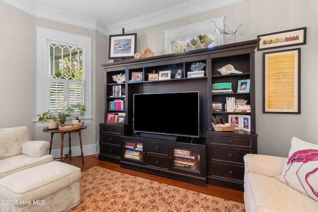 living room featuring crown molding, wood finished floors, and baseboards