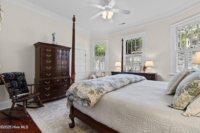 bedroom featuring crown molding, multiple windows, a ceiling fan, and visible vents