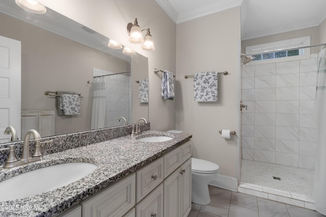 bathroom with toilet, ornamental molding, a tile shower, and a sink