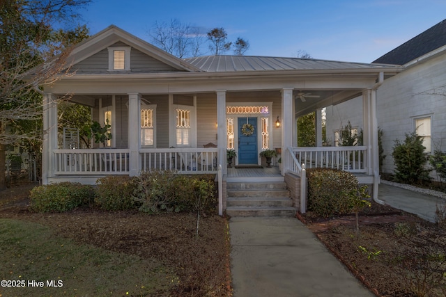 view of front facade with covered porch and metal roof