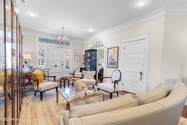 living area featuring crown molding, recessed lighting, visible vents, and a chandelier