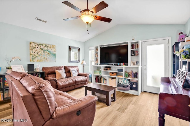 living room with light wood-type flooring, visible vents, ceiling fan, and vaulted ceiling